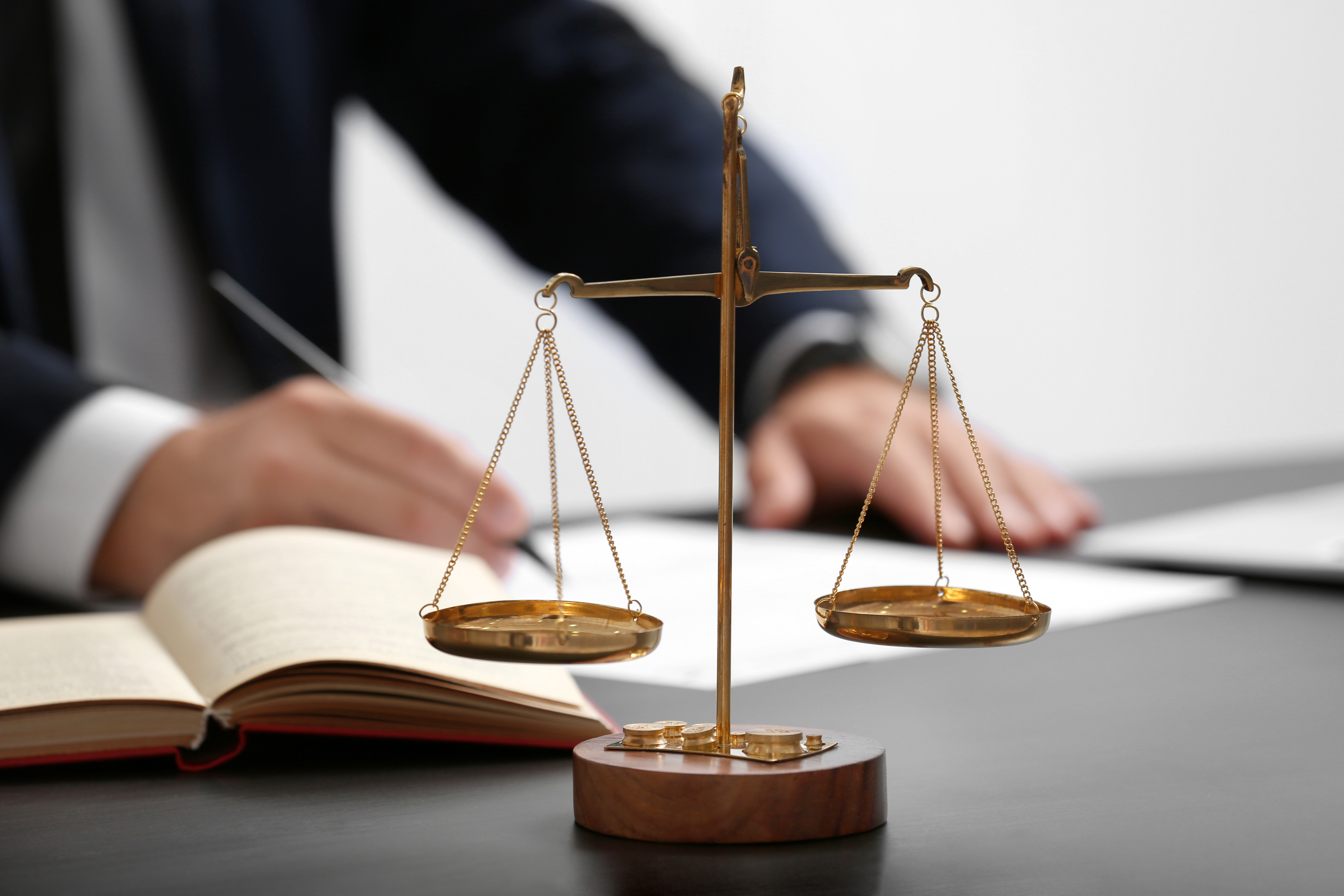 Scales of justice and law book on a table